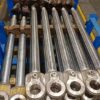 CNC turning operation on forged steel piston rod showing precision machining