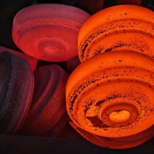 Hot forged rollers for heavy-duty industrial equipment and mining applications