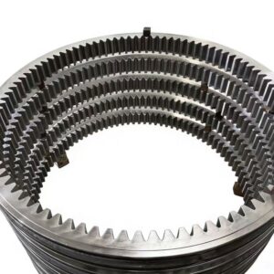 Large slewing bearing rings with machined bolt-hole patterns stacked in a workshop