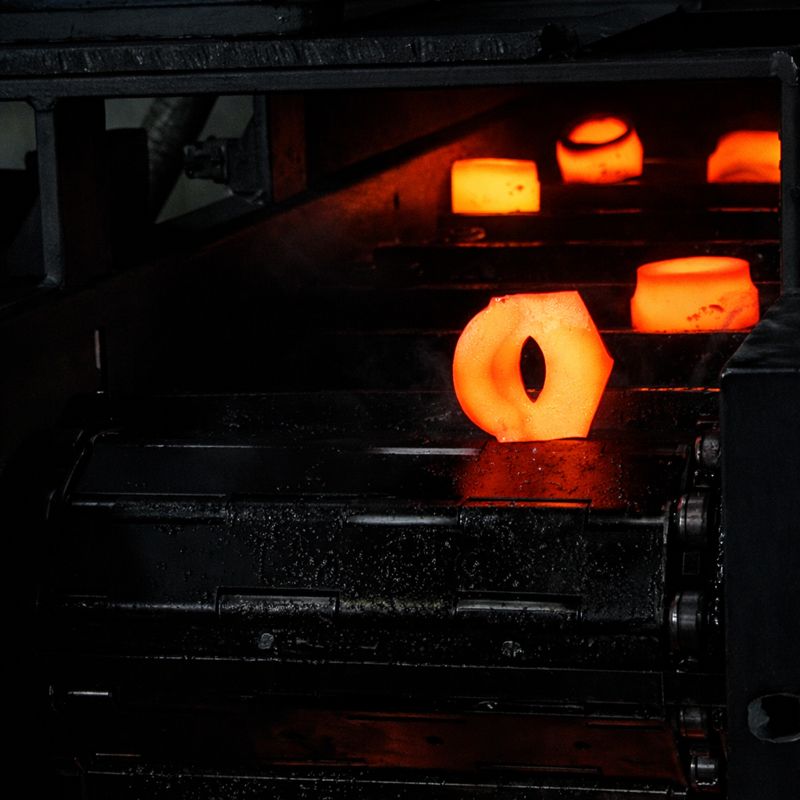 stainless steel hot forging process showing heated billets in industrial forging line