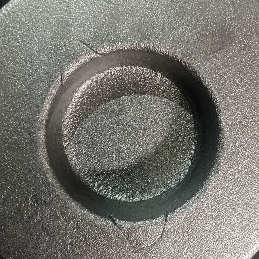 Forging lap defect visible around a forged hole caused by improper metal flow during closed-die forging