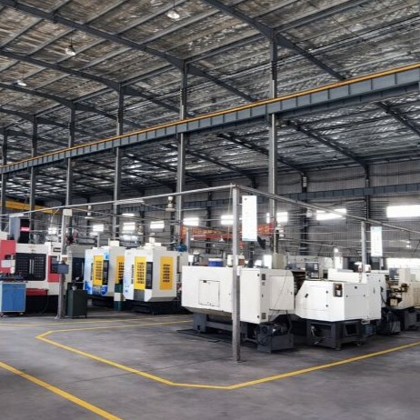 CNC machining workshop with multiple machines showing production environment and factors affecting machining cost