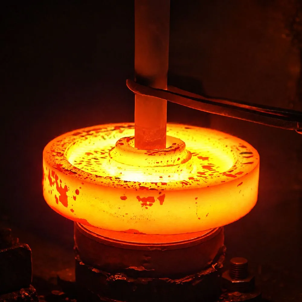 Hot forged steel component being processed for manufacturing custom OEM forged parts for industrial equipment applications