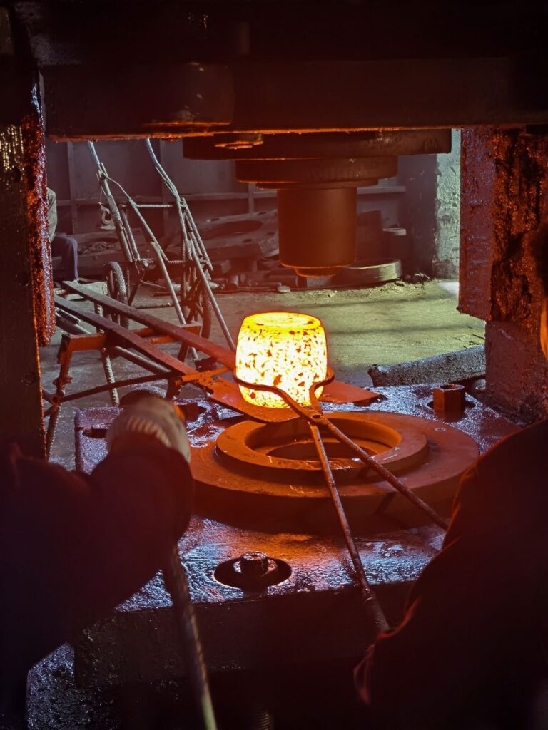 Heated preformed workpiece ready for final forming in a forging die