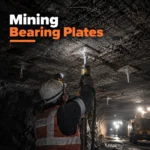 Mining bearing plates installed with rock bolts and mesh in an underground ground support system