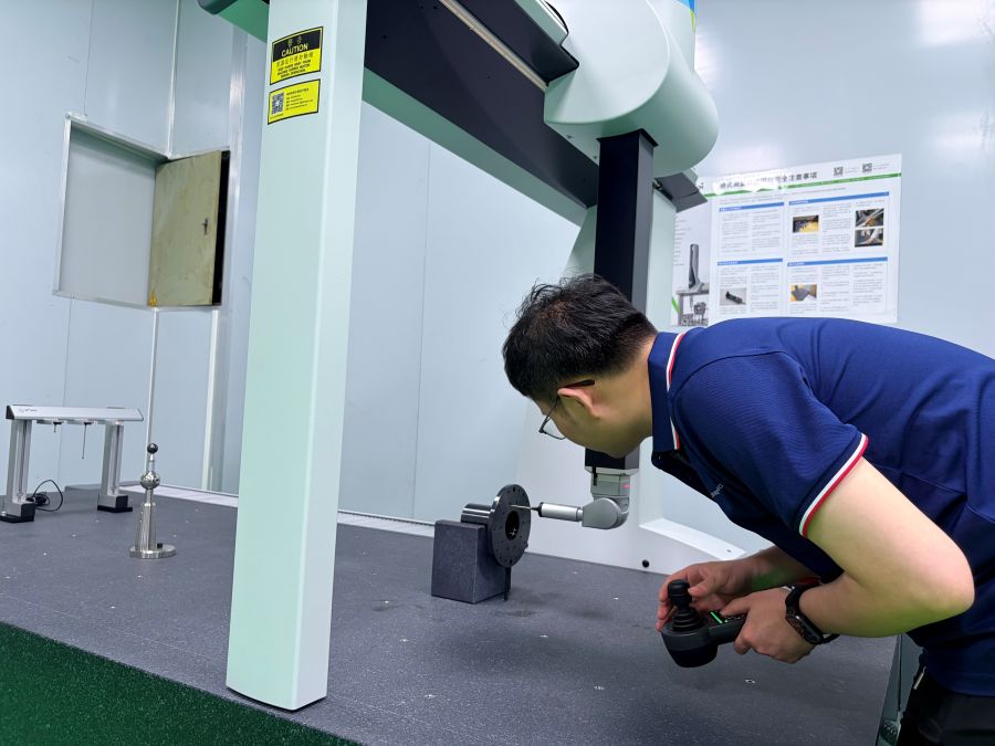 Technician preparing a precision machined gear shaft for CMM dimensional inspection