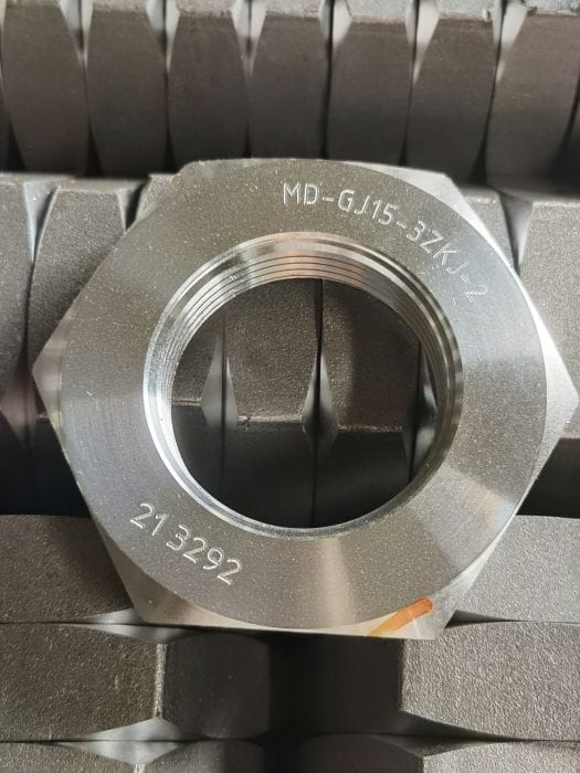 Laser-marked precision machined component for production traceability